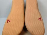 the soles of a pair of women ' s shoes are shown on a cardboard box