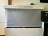 a picture of a white counter with a tv above it