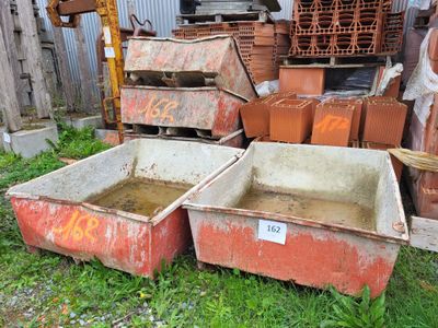 two bins that are sitting in the grass