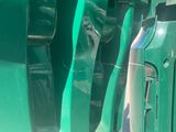 a close up of a green car door handle