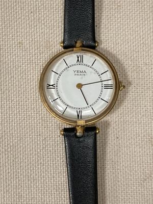 une image d'un gros plan d'une montre-bracelet avec des chiffres romains