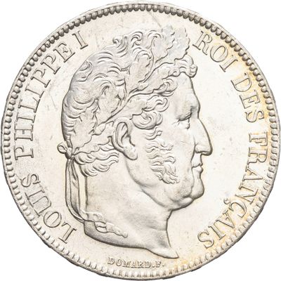 gros plan d'une pièce de monnaie sur laquelle figure une tête d'homme