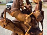 a statue of a horse that is sitting on top of a tree stump
