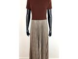 a mannequin mannequin wearing a brown shirt and plea skirt