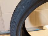 the tire of a motorcycle is sitting on the floor next to a cardboard box