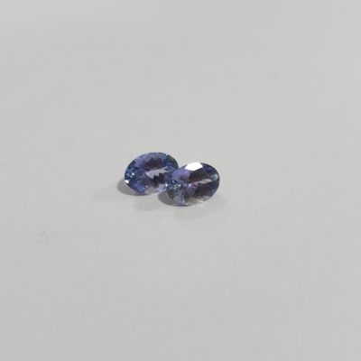 a pair of blue sapphires on a white surface