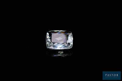a white diamond on a black surface with a black background