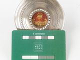 a silver coin on top of a green card
