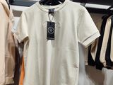 two shirts hanging on a rack in a clothing store