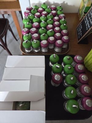 a table with a bunch of green and purple apples on it