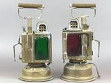 two old fashioned lamps that are sitting on a table