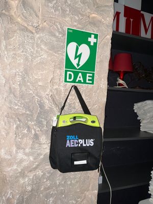 a bag hanging on a wall next to a fire extinguisor