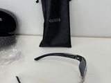 a pair of glasses sitting on a table next to a black bag