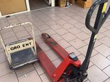 a fork lifter sitting on the ground in front of a building