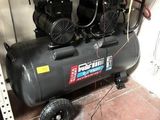 two air compressors sitting on a shelf in a room