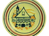 a yellow plate with a picture of a house on it