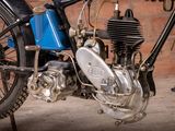 a blue motorcycle parked in front of a brick wall