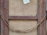 a picture of an old wooden frame with a tag attached to it