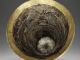 an image of a close up of a metal bowl with a ball inside of it