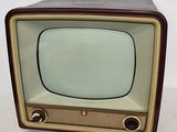 an old fashioned television sitting on a white surface