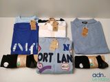 a lot of t - shirts that are sitting on a table