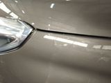 a close up of a car ' s headlight with a blurry background