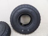 two black tires sitting next to each other on a white surface