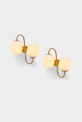 pair of gold plated wall sconces with white glass shades