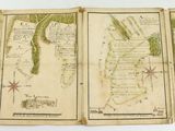 three old maps of the world are shown on a table