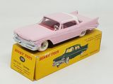 a pink toy car sitting on top of a yellow box