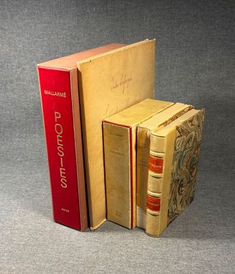 three books are stacked on top of each other on a gray surface