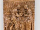 relief en bois représentant un homme et une femme dans une cuisine