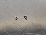 two small pieces of metal on the surface of a sink