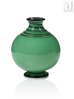 a green vase that is sitting on a white surface