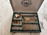 silverware in a green case on a marble counter top