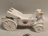 porcelain figurine of a horse drawn carriage with a bird on the back