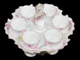 a picture of a white and pink tea set on a plate