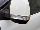 a white car that is parked on the side of the road
