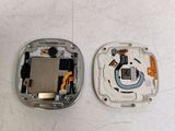 two pieces of metal that have been removed from a cell phone