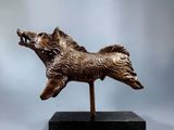 bronze sculpture of a dog on a black base on a gray background