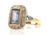 an image of a ring with a blue stone in it