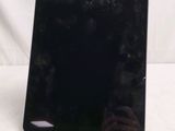 someone is taking a picture of a black tablet computer on a white surface