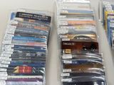 a lot of dvds in the plastic bags on the table