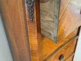 a wooden cabinet with a mirror on top of it