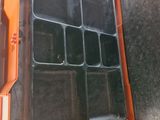a plastic container with compartments inside of it on a table