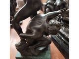 an image of a statue of a man wrestling a woman on a table