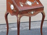 a small wooden table with a clock on it