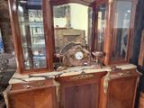 a wooden cabinet with a mirror and a clock on it