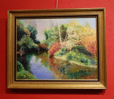 a painting hanging on the wall of a red room