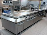 a large kitchen with stainless steel appliances and counters
